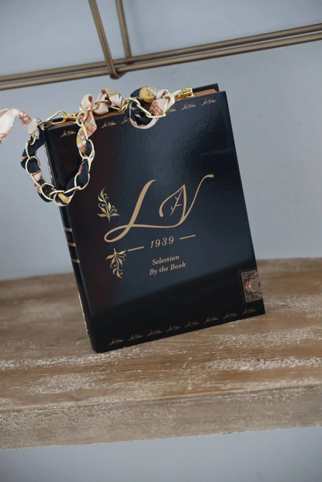 Black cigar-box handbag with gold-toned chain-style handle