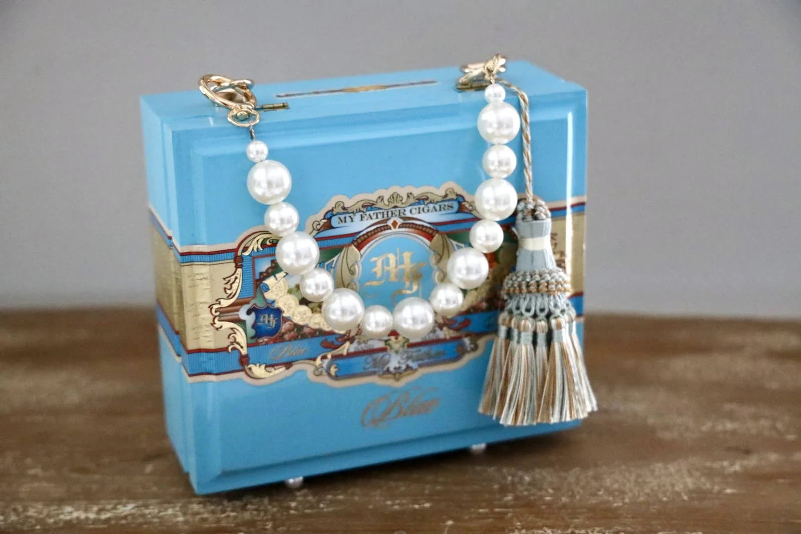 Turquoise cigar-box handbag with decorative beaded handle and tassel
