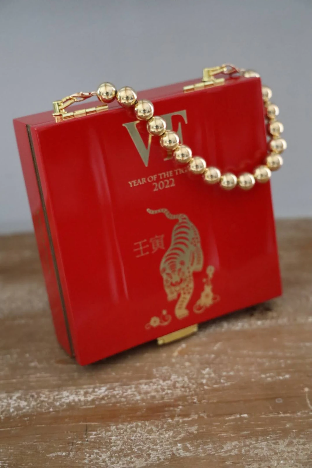Red cigar-box handbag with decorative beaded handle